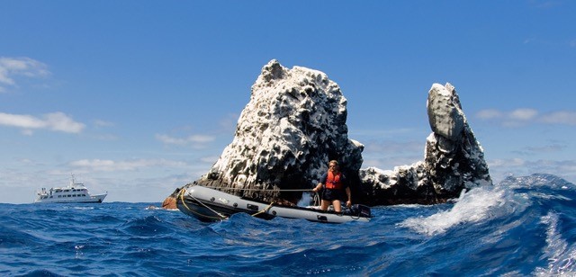 skiff operator with sunglasses passes by roca partida and the nautilus explorer