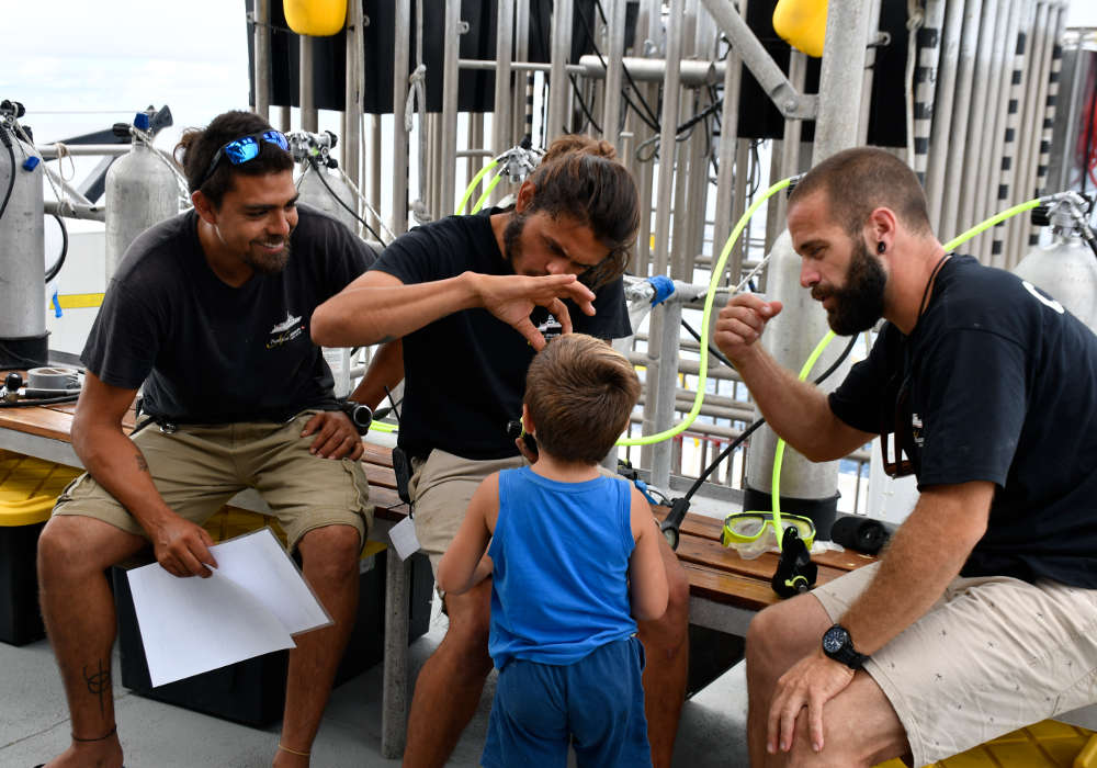 Divemaster talking about sharks to a Kid